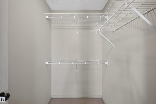 Built-in wire shelving system, neutral wall paint, and textured ceiling - 6116 8 Avenue Sw, Edmonton, AB 