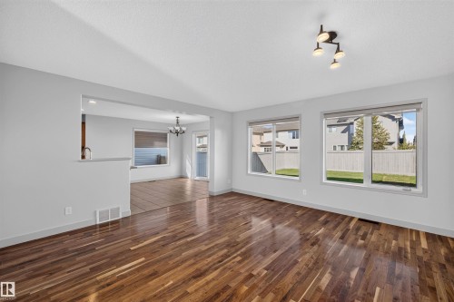 Hardwood flooring, recessed lighting, and large windows - 6116 8 Avenue Sw, Edmonton, AB 