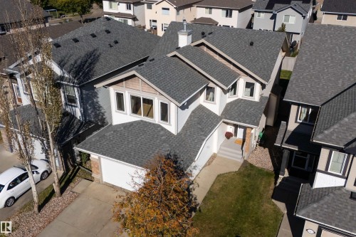 Asphalt shingle roofing, attached garage, multiple gables, front entry with steps, and concrete driveway - 6116 8 Avenue Sw, Edmonton, AB 