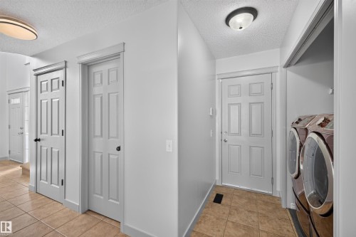 Tile flooring, six-panel doors, overhead lighting, and built-in laundry appliances - 6116 8 Avenue Sw, Edmonton, AB 