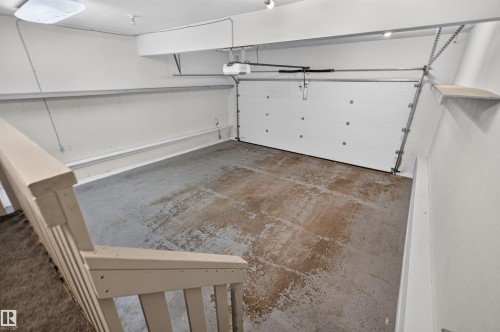 Attached garage with a white overhead door and automatic opener - 6116 8 Avenue Sw, Edmonton, AB 