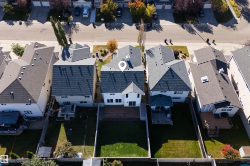 Two-story residential property with a dark shingle roof and light-colored siding - 6116 8 Avenue Sw, Edmonton, AB 