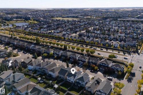 Established residential area with a prominent roadway and a distant body of water - 6116 8 Avenue Sw, Edmonton, AB 