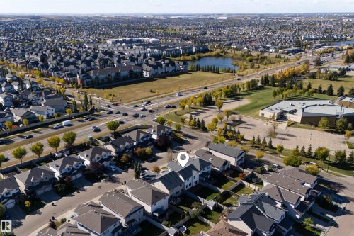 Residential neighborhood with diverse housing, mature trees, and a visible body of water - 6116 8 Avenue Sw, Edmonton, AB 