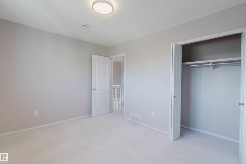 Neutral-toned walls, plush carpeting, and a flush-mount ceiling light - 11526 9 Avenue Nw, Edmonton, AB 