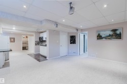 Recessed lighting, drop ceiling, white paneled doors, built-in cabinetry, and tile flooring - 