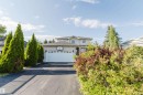 Two-story residence featuring a two-car garage, paved driveway, and mature landscaping - 11526 9 Avenue Nw, Edmonton, AB 