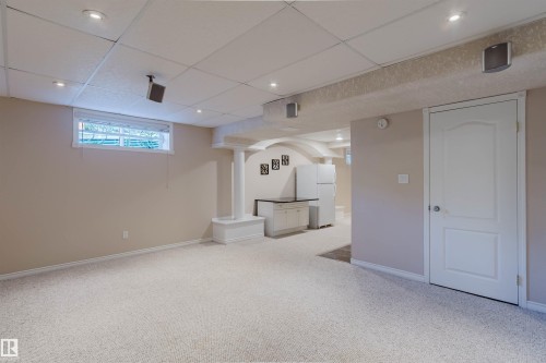 Recessed lighting, light-toned carpeting, window, white paneled door, and built-in cabinetry - 11526 9 Avenue Nw, Edmonton, AB 