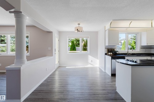 Open-concept living space with wood-finish flooring - 11526 9 Avenue Nw, Edmonton, AB 