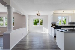 Open-concept living space with wood-finish flooring - 
