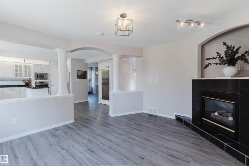 Wood-finish flooring throughout the main living area - 11526 9 Avenue Nw, Edmonton, AB 