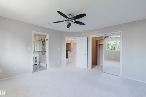 Recessed lighting, ceiling fan with light fixture, mirrored closet doors, and wood-finish closet shelving - 11526 9 Avenue Nw, Edmonton, AB 