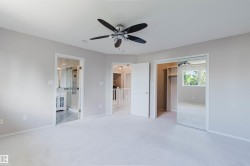 Recessed lighting, ceiling fan with light fixture, mirrored closet doors, and wood-finish closet shelving - 