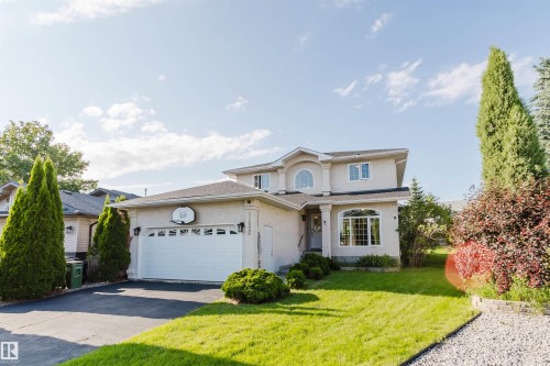 Light-colored stucco exterior with a two-car garage - 11526 9 Avenue Nw, Edmonton, AB 