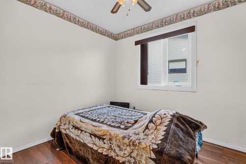 Wood-finish flooring with a white window frame and wall-mounted window treatment - 11 Howson Crescent Nw, Edmonton, AB 