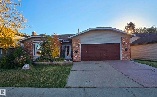 Brick exterior with a prominent bay window and an attached garage - 11 Howson Crescent Nw, Edmonton, AB 