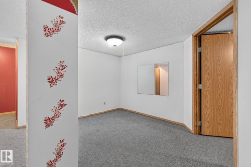 Neutral wall color with a wood-finish door and trim - 11 Howson Crescent Nw, Edmonton, AB 