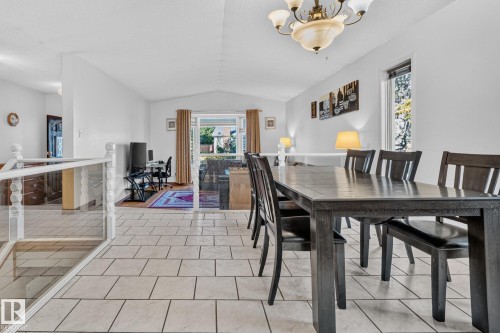 Tiled flooring throughout, white painted walls, and a multi-light chandelier - 11 Howson Crescent Nw, Edmonton, AB 