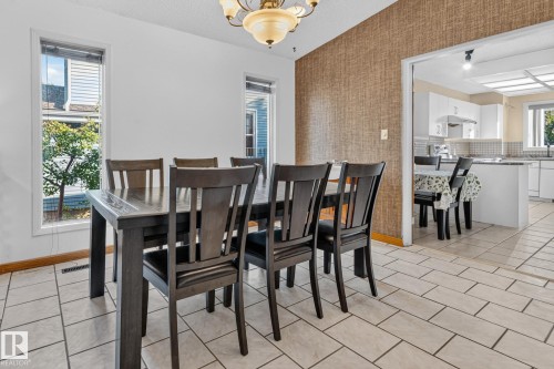Tiled flooring, textured accent wall, two windows, and an arched doorway - 11 Howson Crescent Nw, Edmonton, AB 