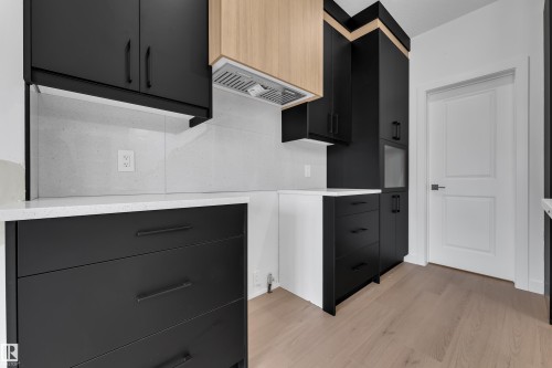 Black cabinetry with linear pull hardware - 58 Silverstone Drive, Stony Plain, AB 