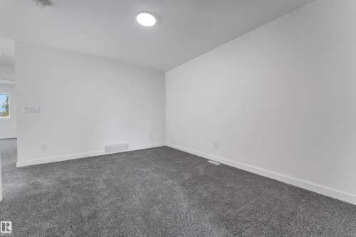Recessed ceiling light fixture, white painted walls, and gray carpet flooring - 58 Silverstone Drive, Stony Plain, AB 