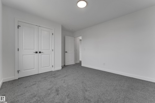 Light gray carpeting, white walls, and white trim - 58 Silverstone Drive, Stony Plain, AB 