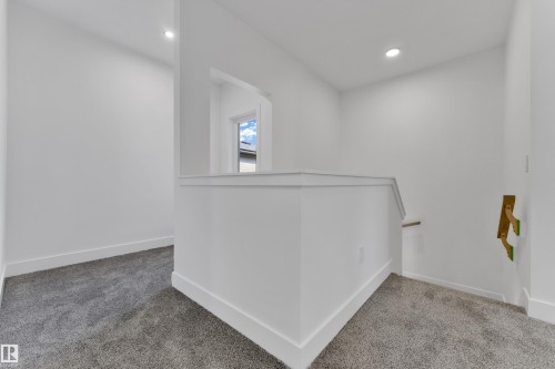 Wall-to-wall carpeting and white walls with recessed lighting - 261 Linden Loop, Leduc, AB 