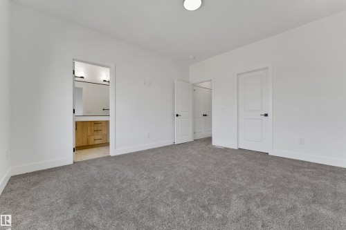 Neutral wall finishes with a recessed ceiling light and grey carpeting - 261 Linden Loop, Leduc, AB 