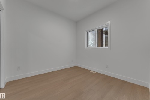 Light wood-finish flooring, white walls, and a window with white trim - 247 Linden Loop, Leduc, AB 