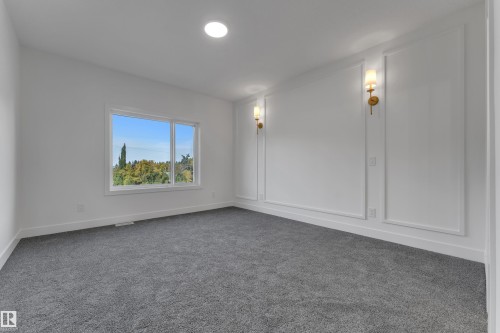 Recessed ceiling lighting, wall sconces, window with exterior scenery, decorative wall molding, and gray carpeting - 247 Linden Loop, Leduc, AB 