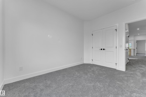 Neutral color palette with light gray carpeting, white walls, and white trim - 247 Linden Loop, Leduc, AB 