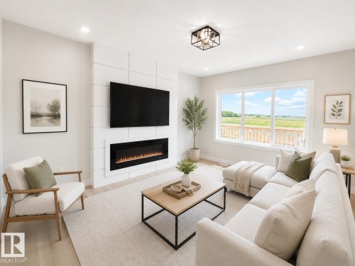 Accent wall with integrated linear electric fireplace, recessed lighting, large picture windows, wood-finish flooring, and a modern flush-mount ceiling fixture - 3718 67 Street, Beaumont, AB 