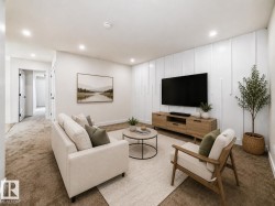 Recessed lighting, white plank accent wall, built-in media console, light neutral carpeting, and white painted walls - 