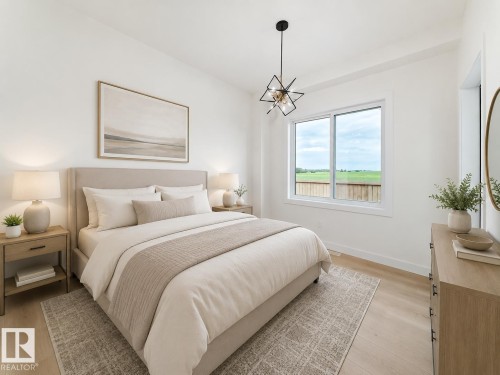 Recessed lighting, wood-finish flooring, a contemporary ceiling fixture, and a large sliding window - 3718 67 Street, Beaumont, AB 