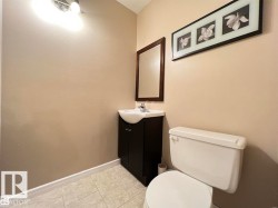 Vanity with a white vessel sink, dark wood-finish cabinet, and a framed mirror - 