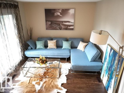 Wood-finish flooring throughout the space - 144 Kaskitayo Court Nw, Edmonton, AB 