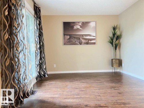 Wood-finish tile flooring, neutral wall color, and white trim - 144 Kaskitayo Court Nw, Edmonton, AB 