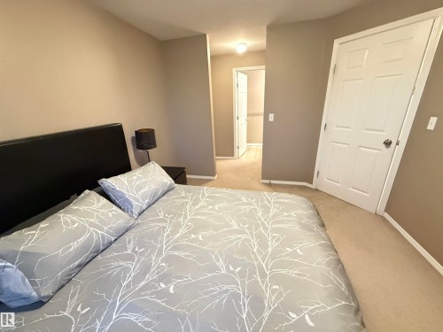 Carpeted flooring with light neutral wall paint - #302 4309 33 St, Stony Plain, AB 
