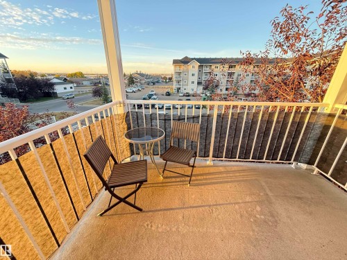 Concrete balcony with white railing - #302 4309 33 St, Stony Plain, AB 