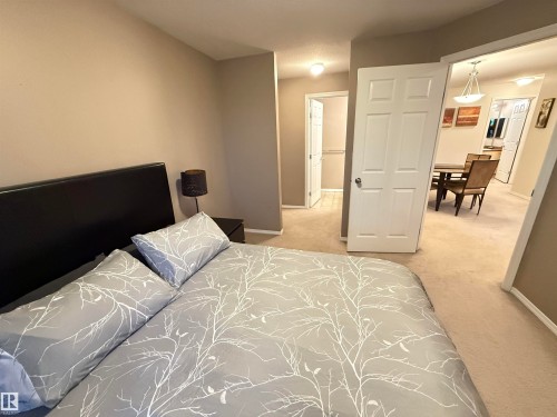 Neutral tone wall finishes, white trim, and light-colored carpeting - #302 4309 33 St, Stony Plain, AB 