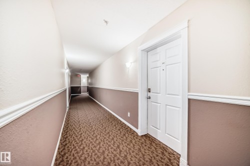 Textured wall covering with chair rail molding - #302 4309 33 St, Stony Plain, AB 