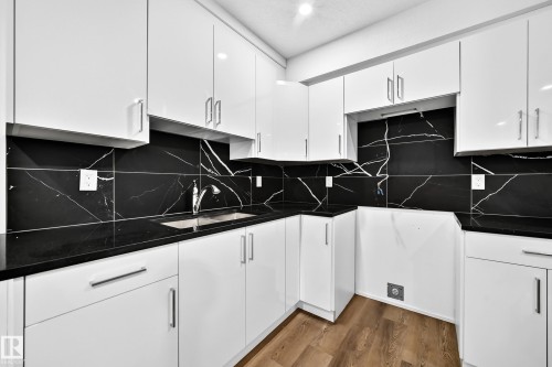 White shaker-style cabinetry with chrome hardware - 1673 Cunningham Way Sw, Edmonton, AB 