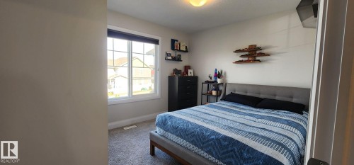 Carpeted flooring, recessed lighting, and a large window with white trim - 3779 Cherry Loop Sw, Edmonton, AB 