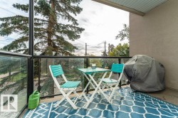 Private balcony with concrete flooring and glass panel railing - 