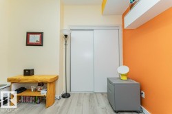 Light wood-finish flooring with white baseboards - 