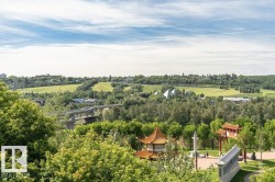 Expansive parkland with mature trees, green spaces, and distinct architectural structures - 