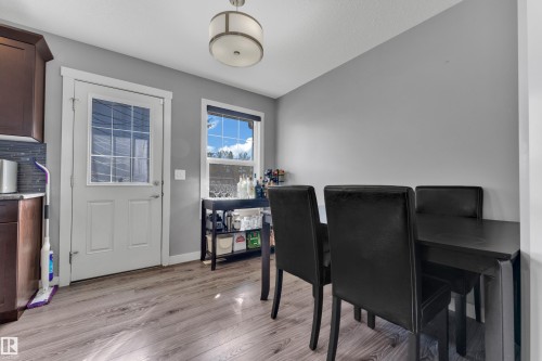Wood-finish flooring, white trim, recessed window, glass panel door, and ceiling-mounted light fixture - #22 4205 30 St Nw, Edmonton, AB 