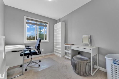 Room featuring a window with a white frame, light-colored carpeting, and light gray wall paint - #22 4205 30 St Nw, Edmonton, AB 