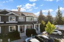 Two-story attached dwelling with dark siding and light trim - #22 4205 30 St Nw, Edmonton, AB 