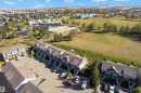 Townhome property with asphalt shingle roofing and an exterior featuring dormer windows - #22 4205 30 St Nw, Edmonton, AB 